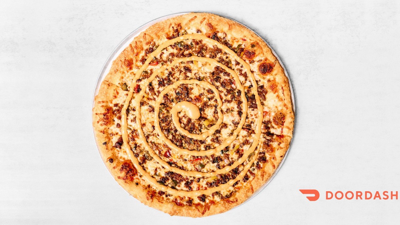 The Marcy kosher pizza with vegan meat jalapeños and spicy sauce at Benny's Bagels Dallas TX